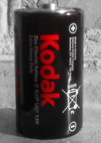 Battery Kodak, red color isolated on black and white background